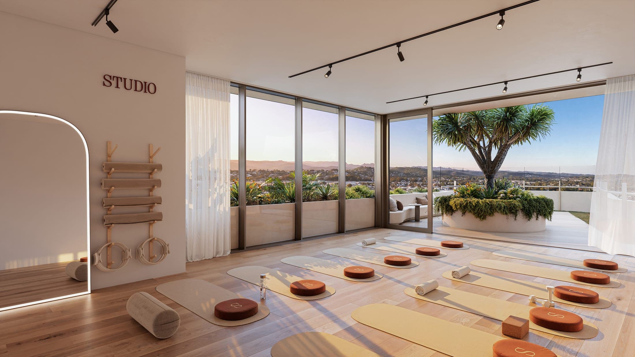 The wellness studio, mats laid out for yoga and pilates with the hinterland beyond the glass