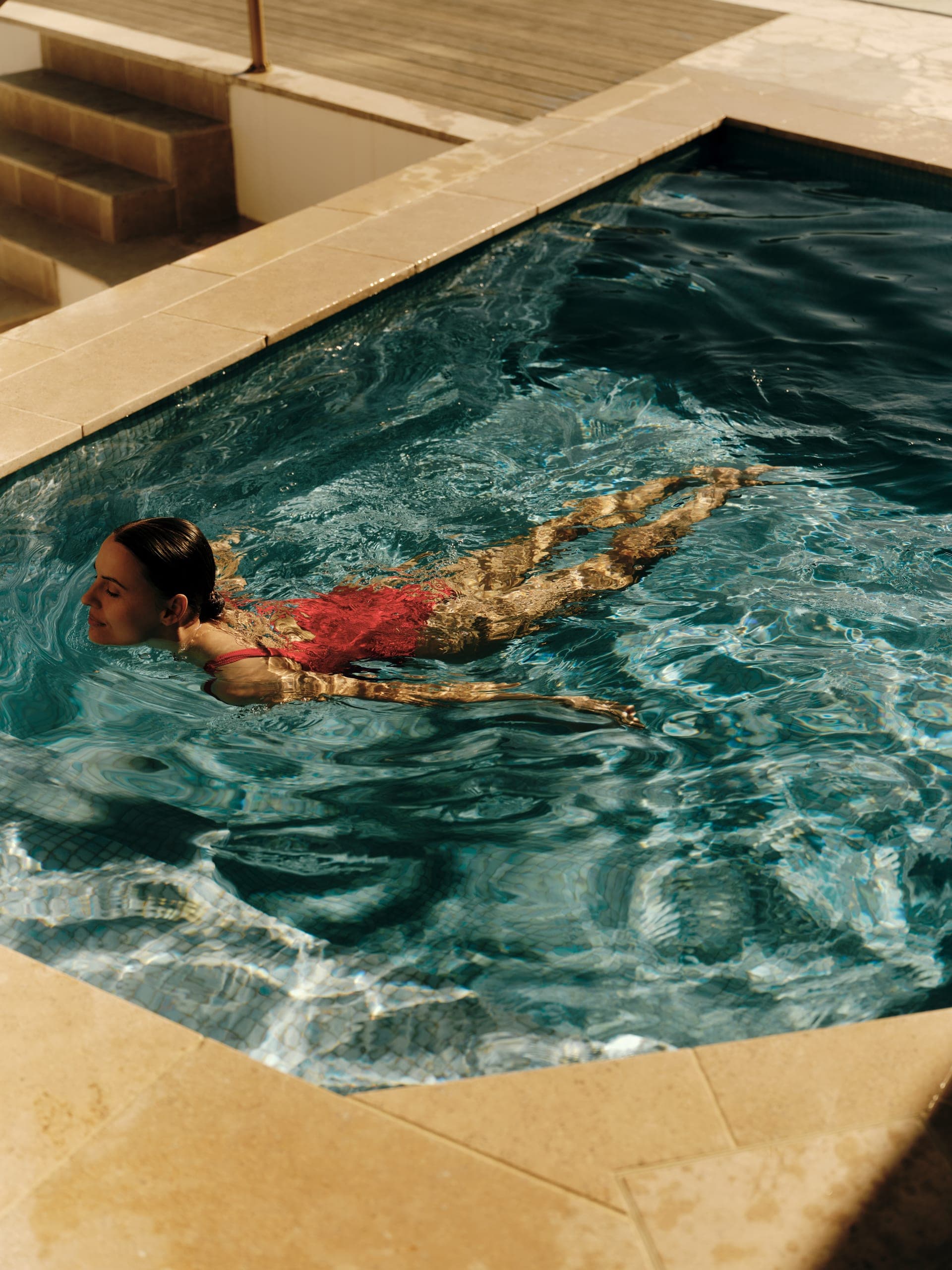 Slow laps in the rooftop pool, late afternoon light over the tiles.