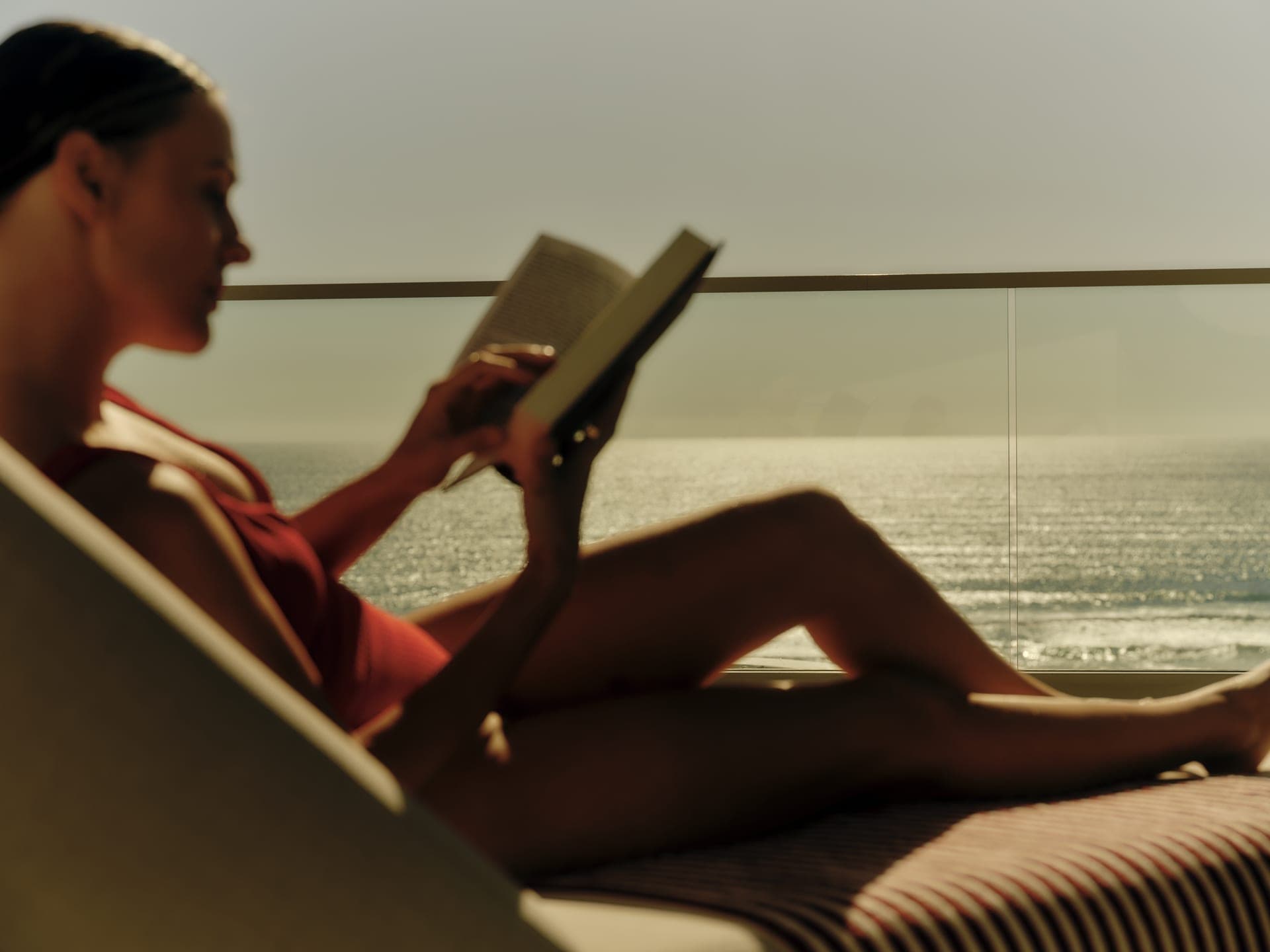 An afternoon spent reading on a sun lounge with the ocean catching the light.